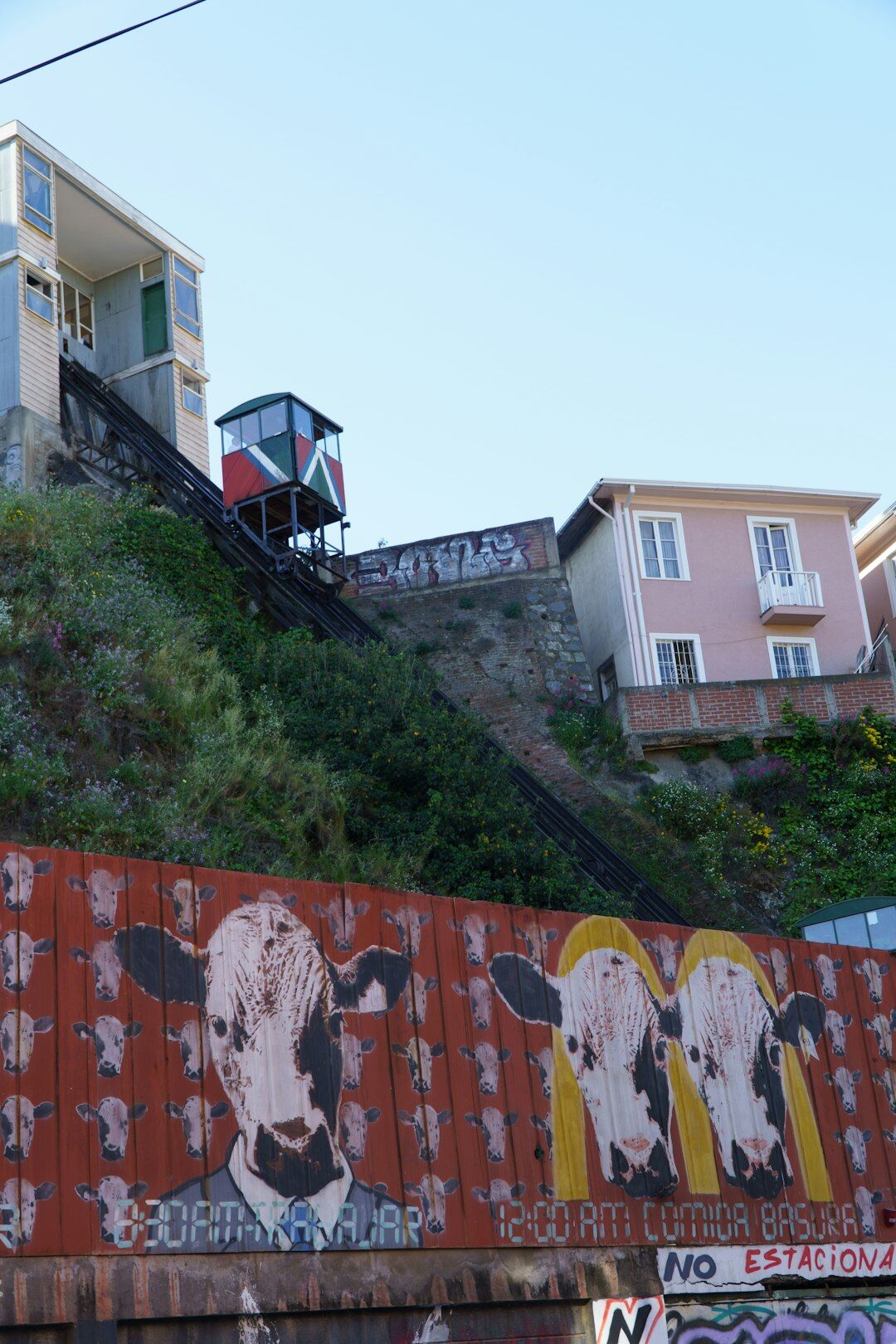street artist painting mural on hill