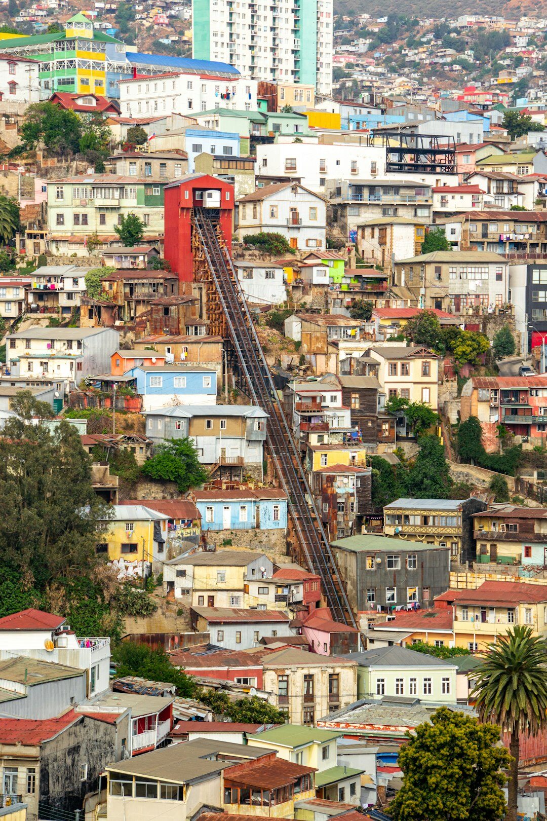 street artist painting mural on hill