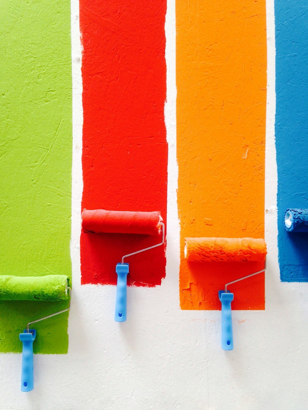 painter working on colorful wall